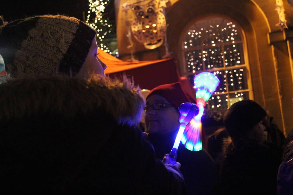 A child enjoys his light-up toy and the Christmas lights at Corsham Town Hall.